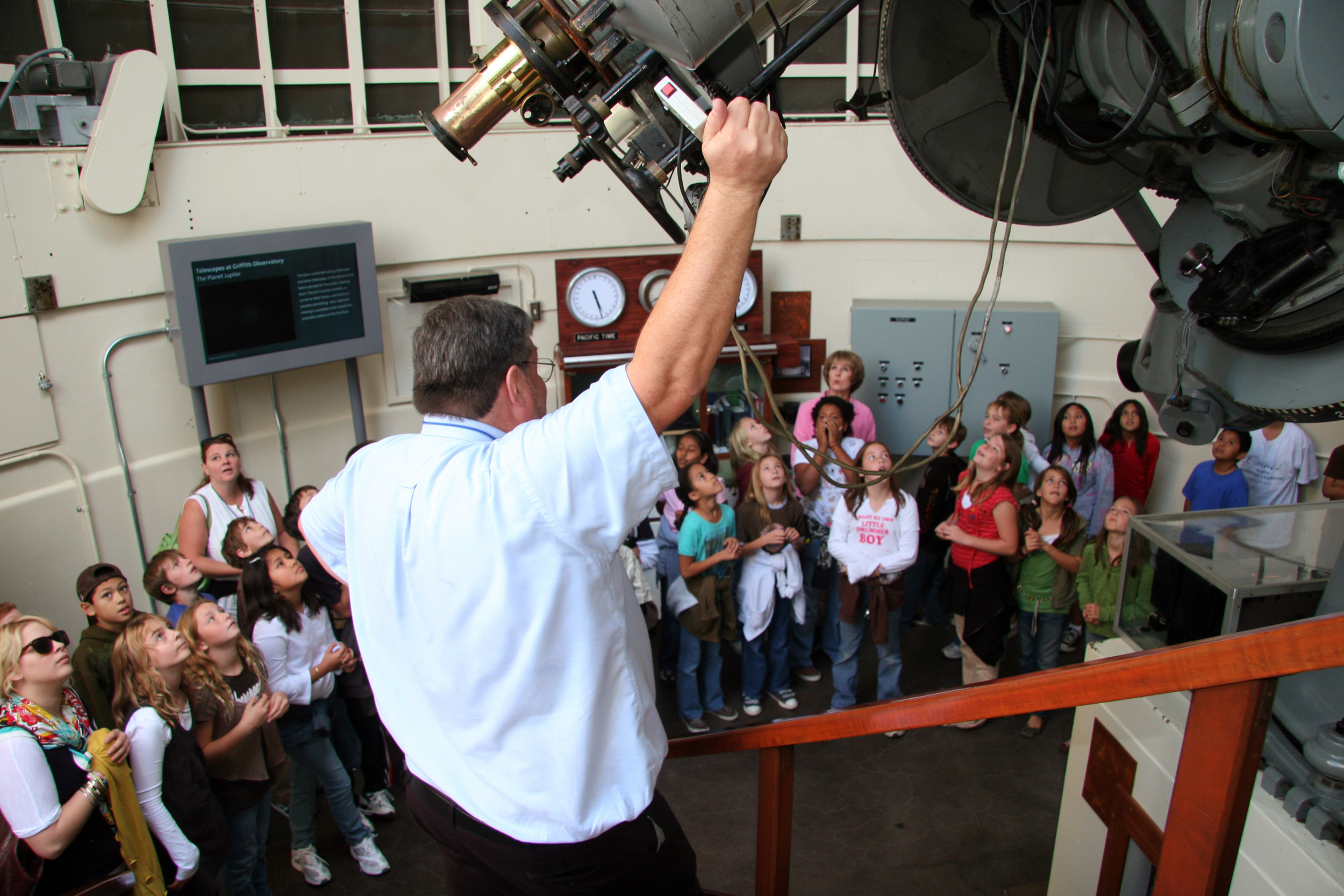 Griffith Observatory Telescope Demonstrator educates a group of children about the Zeiss telescope.